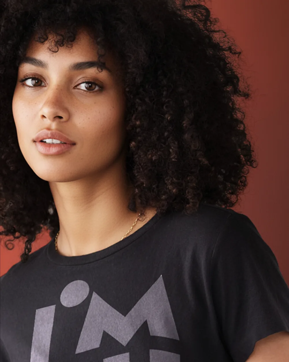 Model wearing the black I’M HUMAN tee, the stacked print in full